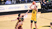 Jan 21, 2025; Iowa City, Iowa, USA; Iowa Hawkeyes forward Payton Sandfort (20) shoots the ball over Minnesota Golden Gophers guard Mike Mitchell Jr. (2) during the second half at Carver-Hawkeye Arena. Mandatory Credit: Jeffrey Becker-Imagn Images