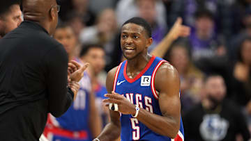 Nov 16, 2024; Sacramento, California, USA; Sacramento Kings guard De'Aaron Fox (5) talks with head coach Mike Brown (left) during the fourth quarter against the Utah Jazz at Golden 1 Center. Mandatory Credit: Darren Yamashita-Imagn Images