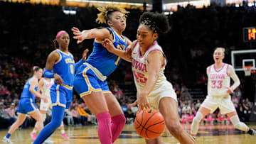UCLA guard Kiki Rice (1) defends Iowa forward Hannah Stuelke (45) as she drives toward the basket Sunday, Feb. 23, 2025 at Carver-Hawkeye Arena in Iowa City, Iowa.