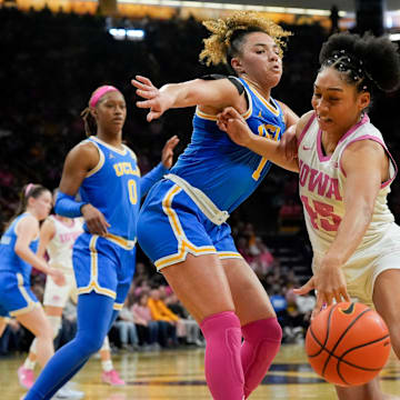 UCLA guard Kiki Rice (1) defends Iowa forward Hannah Stuelke (45) as she drives toward the basket Sunday, Feb. 23, 2025 at Carver-Hawkeye Arena in Iowa City, Iowa.