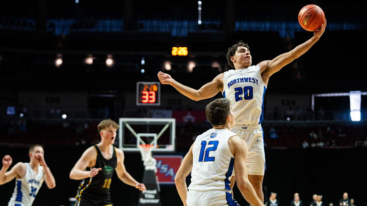 Waukee Northwest's Isaiah Oliver (20) intercepts a pass by Cedar Rapids Kennedy's Landon Deiters (10) on Monday, March 10, 2025, at Wells Fargo Arena in Des Moines.