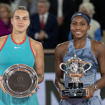 Coco Gauff of the United States poses with Aryna Sabalenka after their match on day 14 at Roland Garros Stadium.