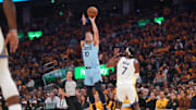 Apr 15, 2025; San Francisco, California, USA; Memphis Grizzlies guard Luke Kennard (10) makes a three point basket over Golden State Warriors guard Buddy Hield (7) in the first quarter at the Chase Center. Mandatory Credit: Cary Edmondson-Imagn Images