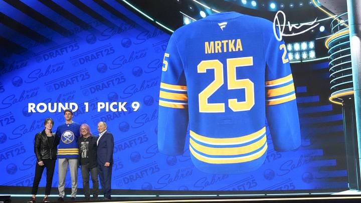 Jun 27, 2025; Los Angeles, California, USA; Radim Mrtka (second from left) poses with John Rzeznik (left) and Robby Takac (second from right) of the Goo Goo Dolls and NHL commissioner Gary Bettman (right) after being selected  as the ninth overall pick to the Buffalo Sabres in the first round of the 2025 NHL Draft at Peacock Theater. Mandatory Credit: Kirby Lee-Imagn Images