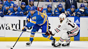 Dec 23, 2023; St. Louis, Missouri, USA;  St. Louis Blues left wing Pavel Buchnevich (89) and Chicago Blackhawks left wing Nick Foligno (17) battle for the puck during the first period at Enterprise Center. Mandatory Credit: Jeff Curry-Imagn Images