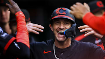 Cincinnati Reds outfielder Austin Hays (12) high fives teammates after scoring on a wild pitch