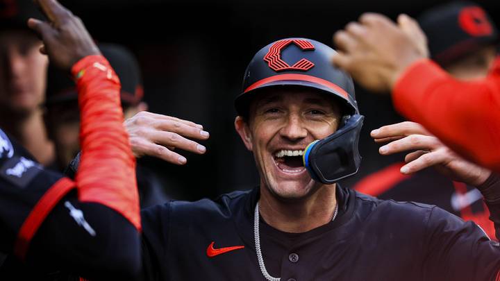 Cincinnati Reds outfielder Austin Hays (12) high fives teammates after scoring on a wild pitch