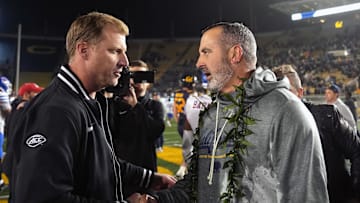 Cal interim head coach Nick Rolovich (right) shakes hands with SMU head coach Rhett Lashlee after the Bears victory over the 21st-ranked Mustangs