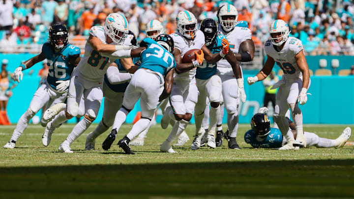 Miami Dolphins running back Jeff Wilson Jr. (23) runs with the football against the Jacksonville Jaguars during the fourth quarter at Hard Rock Stadium in the 2024 opener.