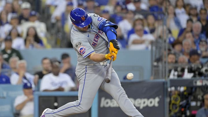 Oct 20, 2024; Los Angeles, California, USA; New York Mets first baseman Pete Alonso (20) hits a single in the third inning against the Los Angeles Dodgers during game six of the NLCS for the 2024 MLB playoffs at Dodger Stadium. Mandatory Credit: Jayne Kamin-Oncea-Imagn Images
