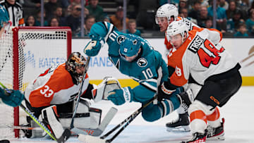 Dec 31, 2024; San Jose, California, USA; San Jose Sharks center Klim Kostin (10) is checked by Philadelphia Flyers center Morgan Frost (48) and defenseman Nick Seeler (24) as goaltender Samuel Ersson (33) protects the net during the second period at SAP Center at San Jose. Mandatory Credit: Robert Edwards-Imagn Images