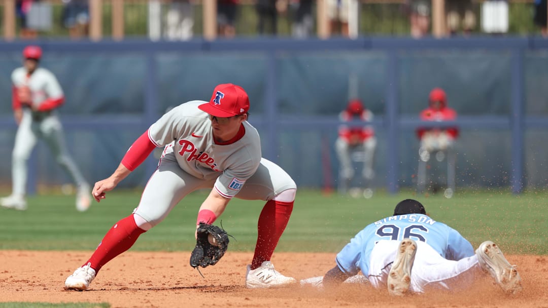 Feb 25, 2025; Port Charlotte, Florida, USA;  Tampa Bay Rays outfielder Chandler Simpson (96) slides safely into second base against Philadelphia Phillies infielder Aidan Miller (81) at Charlotte Sports Park. Mandatory Credit: Kim Klement Neitzel-Imagn Images