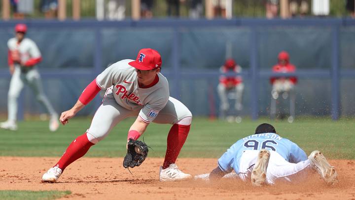 Feb 25, 2025; Port Charlotte, Florida, USA;  Tampa Bay Rays outfielder Chandler Simpson (96) slides safely into second base against Philadelphia Phillies infielder Aidan Miller (81) at Charlotte Sports Park. Mandatory Credit: Kim Klement Neitzel-Imagn Images