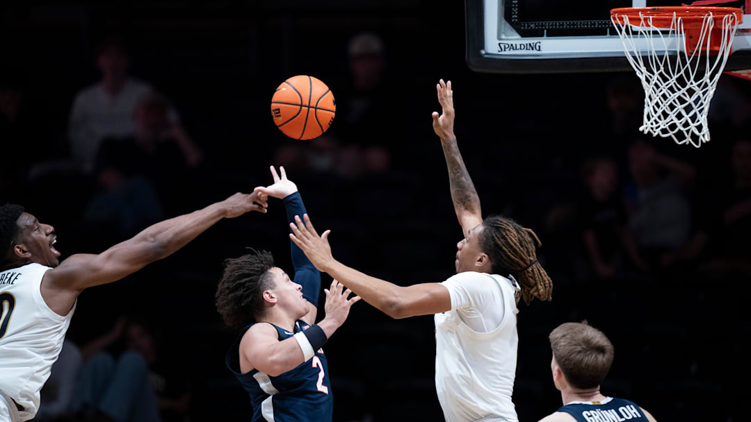 Virginia guard Chance Mallory (2) between Vanderbilt forward Tyler Harris (8) and forward AK Okereke (10) during the second half of their exhibition game at Memorial Gym in Nashville, Tenn., Thursday, Oct. 16, 2025.