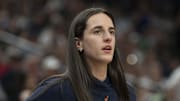 Indiana Fever guard Caitlin Clark looks on from the bench.