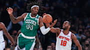 Jan 6, 2022; New York, New York, USA; Boston Celtics center Robert Williams III (44) reaches for loose ball against New York Knicks guard Alec Burks (18) during the first half at Madison Square Garden. Mandatory Credit: Vincent Carchietta-Imagn Images