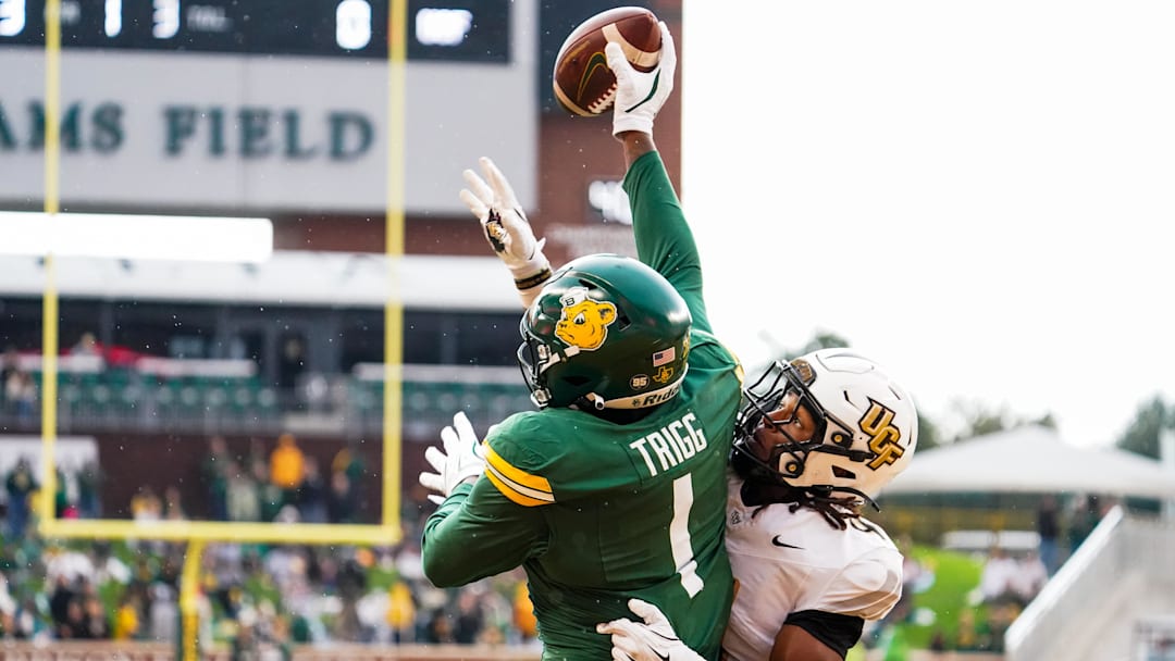 Nov 1, 2025; Waco, Texas, USA; Baylor Bears tight end Michael Trigg (1) catches a touchdown pass as UCF Knights defensive back Braeden Marshall (4) defends during the first half at McLane Stadium. Mandatory Credit: Raymond Carlin III-Imagn Images