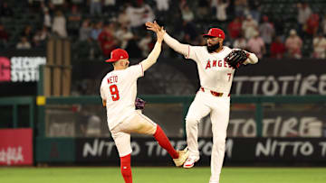 Aug 4, 2025; Anaheim, California, USA;  Los Angeles Angels shortstop Zach Neto (9) and right fielder Jo Adell (7) celebrate after the 5-1 win against the Tampa Bay Rays at Angel Stadium. Mandatory Credit: Kiyoshi Mio-Imagn Images