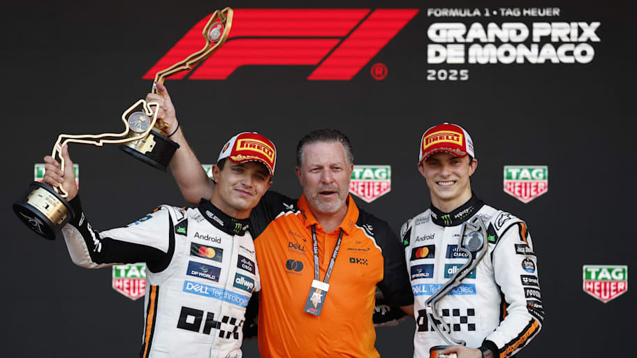 McLaren's Lando Norris (left) celebrates winning the Monaco Grand Prix with CEO Zak Brown (center) and teammate Oscar Piastri