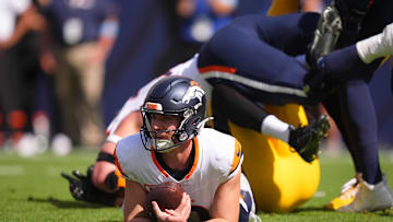 Sep 15, 2024; Denver, Colorado, USA; Denver Broncos quarterback Bo Nix (10) lays on the turf after a sack in the first quarter against the Pittsburgh Steelers at Empower Field at Mile High. Mandatory Credit: Ron Chenoy-Imagn Images