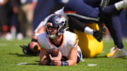 Sep 15, 2024; Denver, Colorado, USA; Denver Broncos quarterback Bo Nix (10) lays on the turf after a sack in the first quarter against the Pittsburgh Steelers at Empower Field at Mile High. 