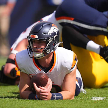 Sep 15, 2024; Denver, Colorado, USA; Denver Broncos quarterback Bo Nix (10) lays on the turf after a sack in the first quarter against the Pittsburgh Steelers at Empower Field at Mile High. 