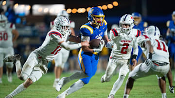 DCA's Carson Sneed (2) runs after a catch as Tipton-Rosemark's Tanner Thornell (12) tries to tackle him during their Division II-A playoff game at Donelson Christian Academy in Nashville, Tenn., Friday, Nov. 8, 2024.