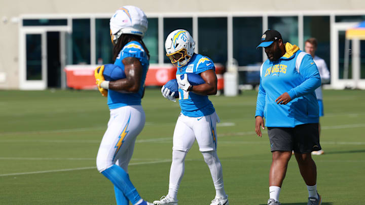 Jul 24, 2024; El Segundo, CA, USA;  Los Angeles Chargers running back J.K. Dobbins (27) holds balls during the first day of training camp at The Bolt. Mandatory Credit: Kiyoshi Mio-Imagn Images