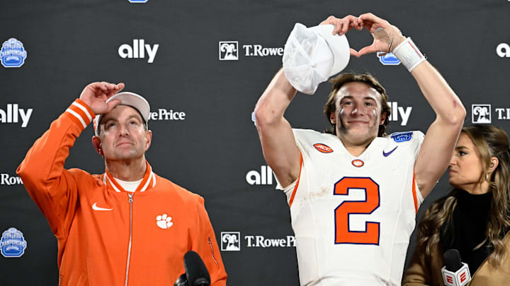 Dec 7, 2024; Charlotte, NC, USA; Clemson Tigers head coach Dabo Swinney, and quarterback Cade Klubnik (2) celebrate after winning the 2024 ACC Championship game against the Southern Methodist Mustangs at Bank of America Stadium. Mandatory Credit: Bob Donnan-Imagn Images