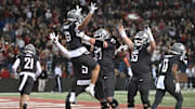 Nov 15, 2025; Pullman, Washington, USA; Washington State Cougars wide receiver Joshua Meredith (18) celebrates with Washington State Cougars offensive lineman Jonny Lester (67) after a touchdown against the Louisiana Tech Bulldogs in the first half at Gesa Field at Martin Stadium. Mandatory Credit: James Snook-Imagn Images