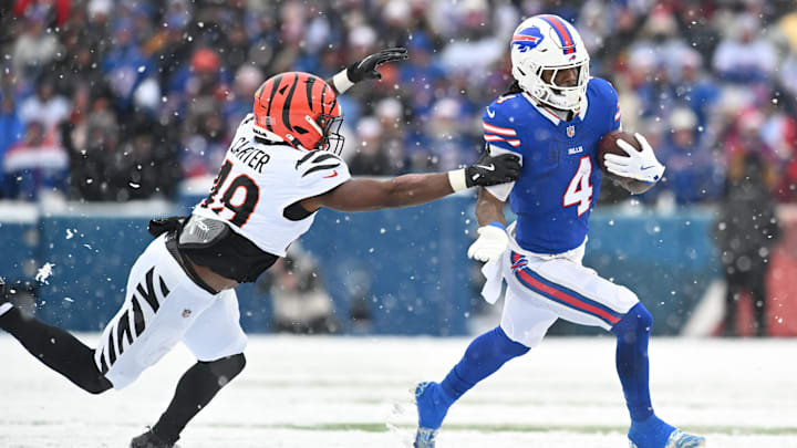 Dec 7, 2025; Orchard Park, New York, USA; Buffalo Bills running back James Cook III (4) runs with the ball while defended by Cincinnati Bengals linebacker Barrett Carter (49) in the second half at Highmark Stadium. Mandatory Credit: Mark Konezny-Imagn Images