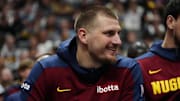 Denver Nuggets center Nikola Jokic (15) reacts from the bench in the second quarter against the Washington Wizards at Ball Arena. 