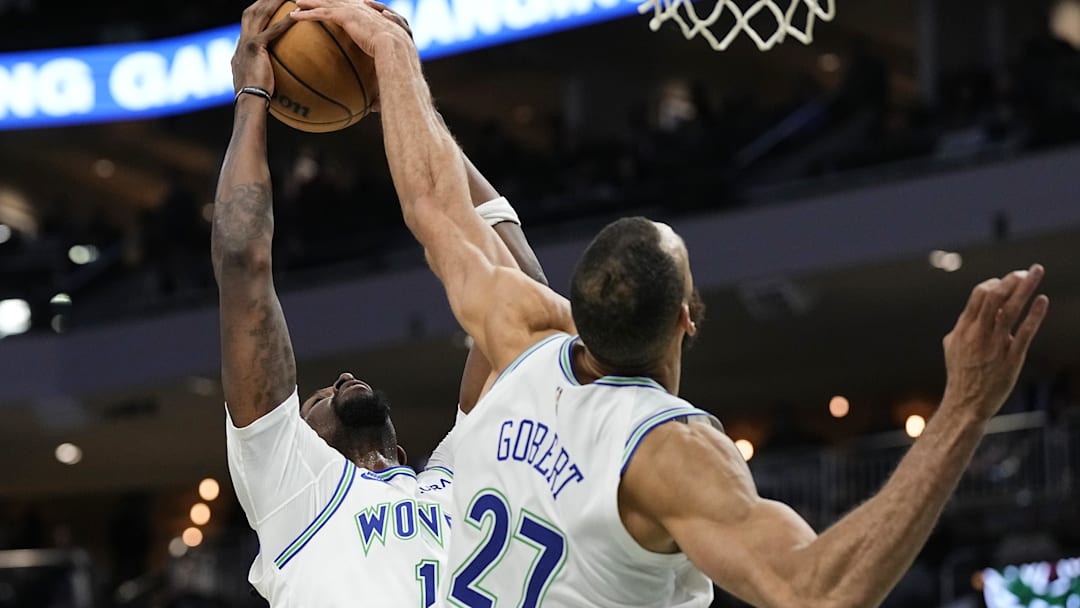 Feb 8, 2024; Milwaukee, Wisconsin, USA;  Minnesota Timberwolves center Naz Reid (11) and center Rudy Gobert (27) reach for a rebound during the fourth quarter against the Milwaukee Bucks at Fiserv Forum. Mandatory Credit: Jeff Hanisch-Imagn Images