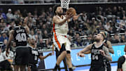 Feb 21, 2025; Austin, Texas, USA; Detroit Pistons guard Cade Cunningham (2) drives to the basket between San Antonio Spurs forwards Harrison Barnes (40) and Sandro Mamukelashvili (54) during the second half at Moody Center. Mandatory Credit: Scott Wachter-Imagn Images