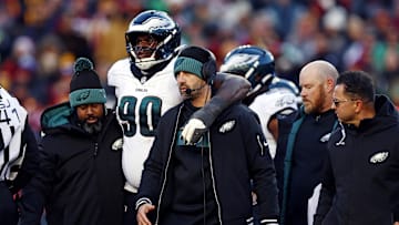 Dec 22, 2024; Landover, Maryland, USA; Philadelphia Eagles head coach Nick Sirianni helps defensive tackle Jordan Davis (90) off the field during the second quarter against the Washington Commanders at Northwest Stadium. Mandatory Credit: Peter Casey-Imagn Images