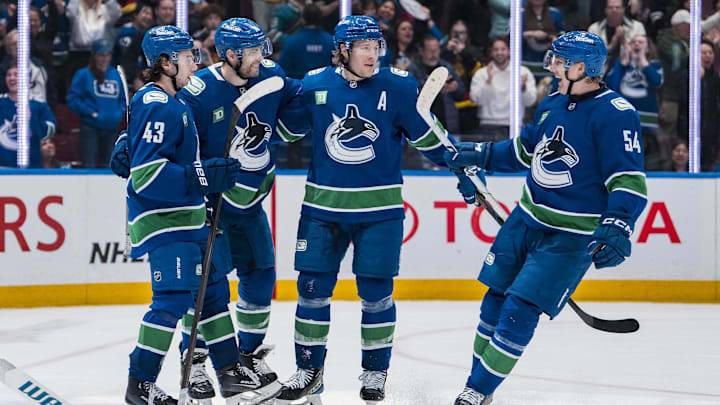 Apr 14, 2025; Vancouver, British Columbia, CAN; Vancouver Canucks forward Jake DeBrusk (74), forward Brock Boeser (6), defenseman Quinn Hughes (43) and forward Aatu Raty (54) celebrate DeBrusk’s goal against the San Jose Sharks in overtime at Rogers Arena. Mandatory Credit: Bob Frid-Imagn Images