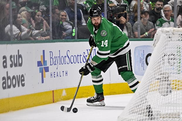 Hockey player skates with the puck