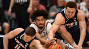 Jan 11, 2025; Stanford, California, USA; Virginia Cavaliers guard Isaac McKneely (11) and Stanford Cardinal forward Donavin Young (center) and Virginia Cavaliers forward Elijah Saunders (right) dive for a loose ball in the first half at Maples Pavilion. Mandatory Credit: Eakin Howard-Imagn Images