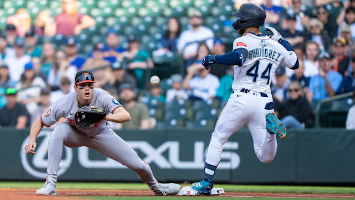 Jun 4, 2025; Seattle, Washington, USA; Seattle Mariners centerfielder Julio Rodriguez (44) beats out a throw to Balitimore Orioles first baseman Coby Mayo (16) during the first inning at T-Mobile Park. Jun 4, 2025; Seattle, Washington, USA; Seattle Mariners centerfielder Julio Rodriguez (44) beats out a throw to Balitimore Orioles first baseman Coby Mayo (16) during the first inning at T-Mobile Park.