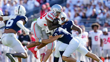 Ohio State Buckeyes running back TreVeyon Henderson (32) runs over Penn State Nittany Lions linebacker Dominic DeLuca (0) during the second half of the NCAA football game at Beaver Stadium in University Park, Pa. on Saturday, Nov. 2, 2024. Ohio State won 20-13.