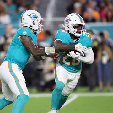 Miami Dolphins quarterback Tua Tagovailoa (1) hands the ball off to running back De'Von Achane (28) during the second quarter of the Week 9 game against Baltimore at Hard Rock Stadium.