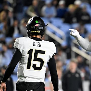 Nov 16, 2024; Chapel Hill, North Carolina, USA; North Carolina Tar Heels defensive lineman Travis Shaw (4) reacts after making a tackle as Wake Forest Demon Deacons quarterback Michael Kern (15) looks to the sideline in the third quarter at Kenan Memorial Stadium. 