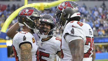 Dec 15, 2024; Inglewood, California, USA; Tampa Bay Buccaneers wide receiver Mike Evans (13) is congratulated by wide receiver Jalen McMillan (15) and offensive tackle Tristan Wirfs (78) after a touchdown in the second half against the Los Angeles Chargers at SoFi Stadium. Mandatory Credit: Jayne Kamin-Oncea-Imagn Images
