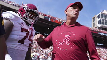 Sep 14, 2024; Madison, Wisconsin, USA;  Alabama Crimson Tide head coach Kalen DeBoer greets offensive linenam Kadyn Proctor (74) prior to the game against the Wisconsin Badgers at Camp Randall Stadium. Mandatory Credit: Jeff Hanisch-Imagn Images