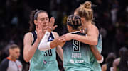 Sep 5, 2025; Seattle, Washington, USA;  New York Liberty forward Breanna Stewart (30) guard Natasha Cloud (9) and forward Leonie Fiebich (13) celebrate after a game against the Seattle Storm at Climate Pledge Arena. Mandatory Credit: Stephen Brashear-Imagn Images