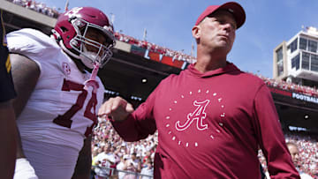 Alabama Crimson Tide head coach Kalen DeBoer greets offensive lineman Kadyn Proctor (74)