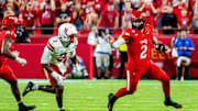 Aug 28, 2025; Kansas City, Missouri, USA; Cincinnati Bearcats quarterback Brendan Sorsby (2) scrambles against Nebraska Cornhuskers defensive back Marques Buford Jr. (3) during the fourth quarter at GEHA Field at Arrowhead Stadium. Mandatory Credit: Dylan Widger-Imagn Images