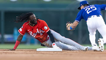 Mar 4, 2025; Phoenix, Arizona, USA; Cincinnati Reds shortstop Elly De La Cruz steals second base ahead of the tag by Los Angeles Dodgers second baseman Tommy Edman during a spring training game at Camelback Ranch-Glendale. Mandatory Credit: Mark J. Rebilas-Imagn Images