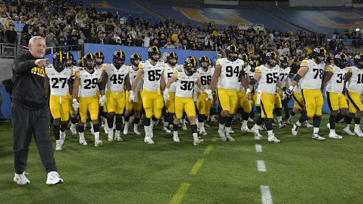 Nov 8, 2024; Pasadena, California, USA;  Iowa Hawkeyes head coach Kirk Ferentz leads his team onto the field for the game against the UCLA Bruins at the Rose Bowl. Mandatory Credit: Jayne Kamin-Oncea-Imagn Images
