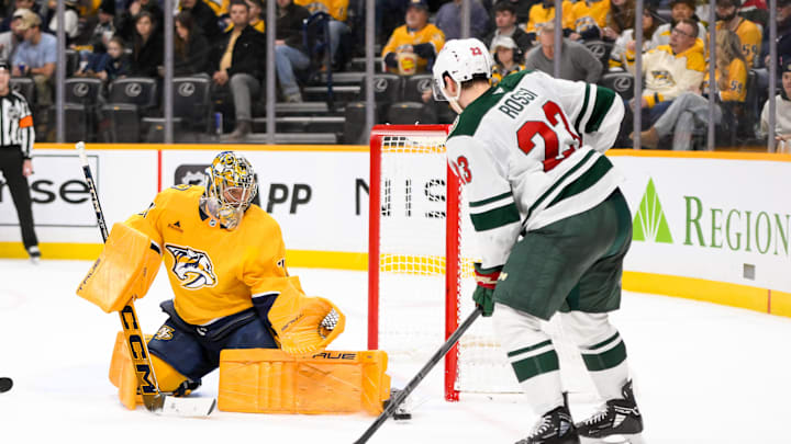 Jan 18, 2025; Nashville, Tennessee, USA;  Nashville Predators goaltender Juuse Saros (74) blocks the shot of Minnesota Wild center Marco Rossi (23) during the second period at Bridgestone Arena. Mandatory Credit: Steve Roberts-Imagn Images